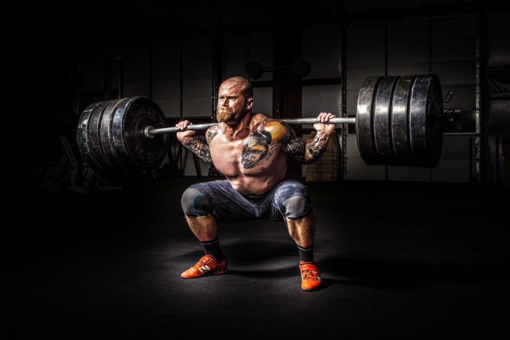 pexels photo 17840 Muscular man lifting heavy weights during an intense squat session inside a gym.